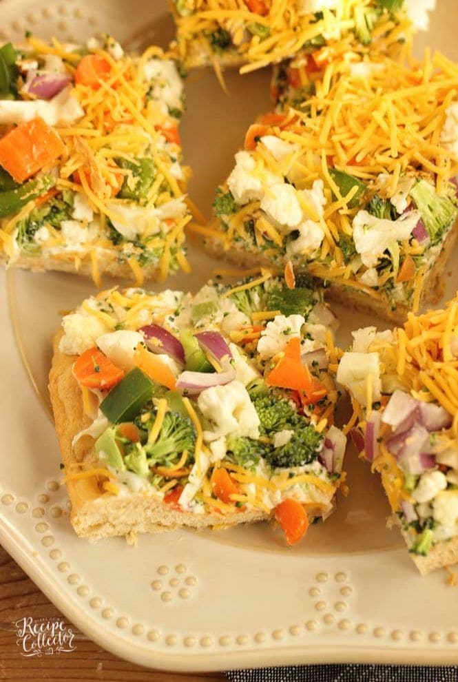 Veggie Squares -This easy appetizer is a great recipe for any get-together.  When you want a break from the ordinary vegetable tray, this is the way to go!  They are always a hit!  Crescent rolls, ranch packet, cream cheese, mayo, veggies, and shredded cheese...super easy!