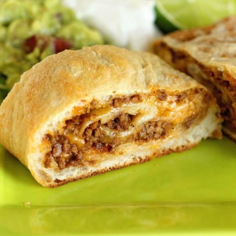 Easy Taco Calzone - A quick and easy weeknight dinner idea using refrigerated pizza dough, taco ground beef filling, and cheese! It's a super kid-friendly meal idea!