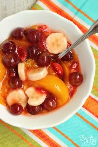 Peach Pie Filling Fruit Salad - This easy dish is made with fresh fruit, frozen strawberries, and mixed with a can of peach pie filling.  It's perfect for school lunches and freezer-friendly too!