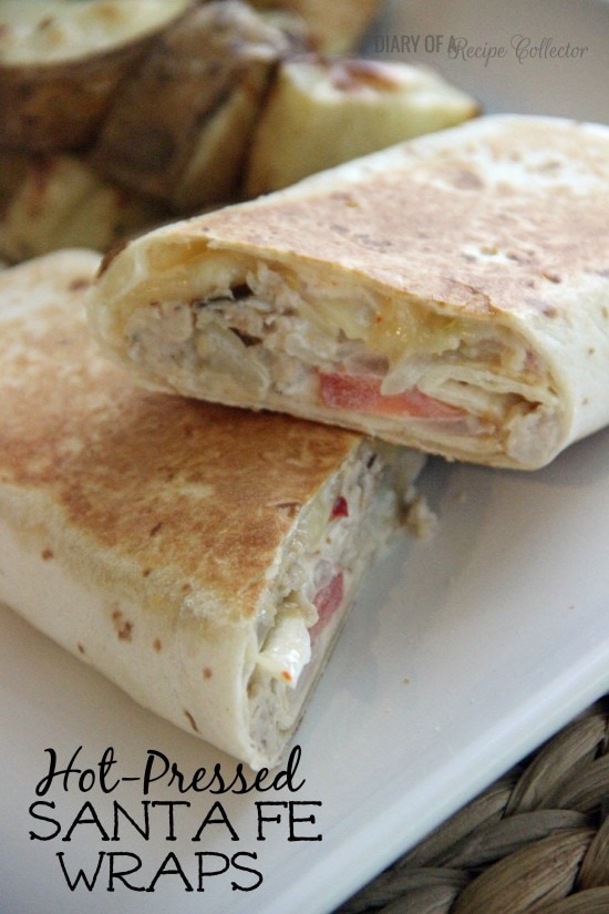 Hot-Pressed Santa Fe Wraps - Hot and melty wraps filled with chicken, pepperjack, sauteed onions, tomatoes, and a mexi-ranch sauce...
