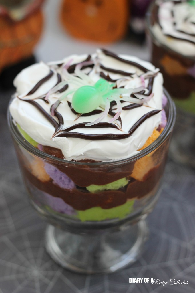 Mini Halloween Trifles - Layers of fun colored cake with pudding and topped off with some spider-webbed whipped cream!  It's a super fun dessert for your kids or grandkids, and it's really quick to put together!