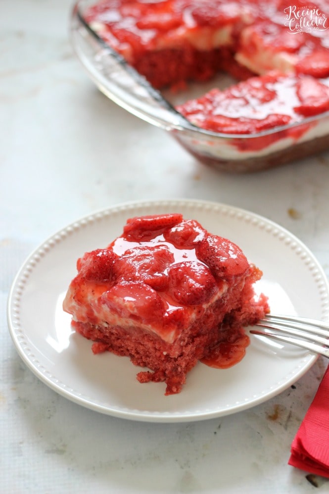 Strawberry Wet Cake - A super moist strawberry cake filled with real strawberries and strawberry jello and topped with a wonderful cream cheese icing and more strawberries!! It's perfect for a crowd!