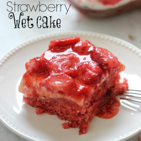 Strawberry Wet Cake - A super moist strawberry cake filled with real strawberries and strawberry jello and topped with a wonderful cream cheese icing and more strawberries!! It's perfect for a crowd!