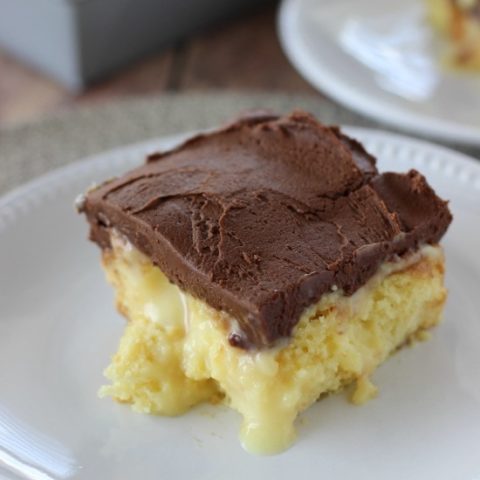 Boston Cream Pie Poke Cake - Major crowd-pleasing cake filled with vanilla pudding and sweetened condensed milk and topped with a homemade chocolate frosting!!