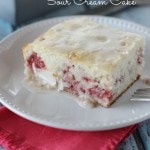 Strawberry Sour Cream Cake – A moist sour cream white cake filled with fresh strawberries and topped with a quick lemon glaze.