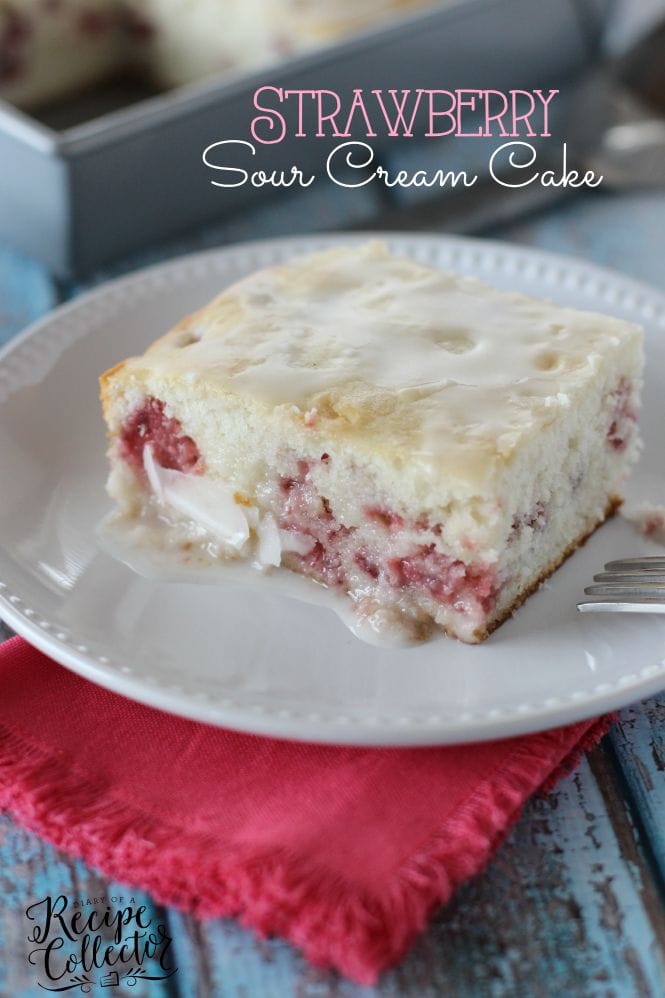 Strawberry Sour Cream Cake – A moist sour cream white cake filled with fresh strawberries and topped with a quick lemon glaze.