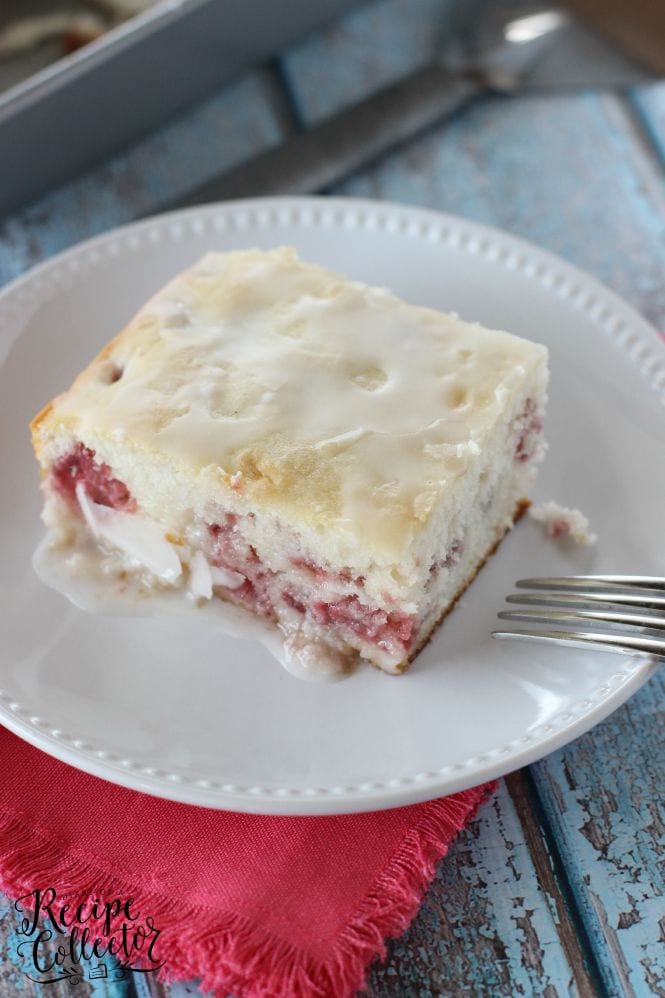 Strawberry Sour Cream Cake – A moist sour cream white cake filled with fresh strawberries and topped with a quick lemon glaze.