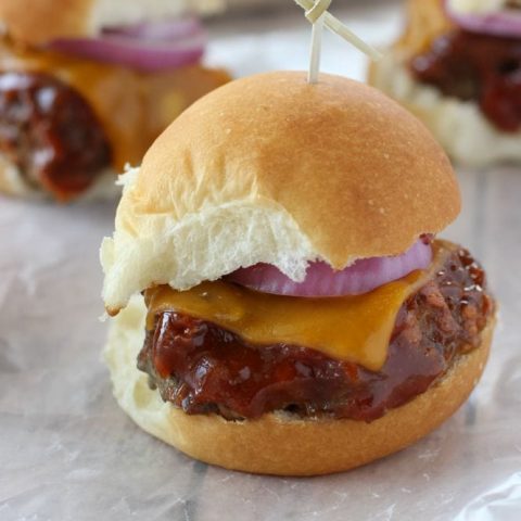 Barbecue Meatloaf & Cheddar Oven Sliders - Baked meatloaf slider burgers topped with a wonderful homemade easy barbecue sauce, cheddar cheese, and red onion. Perfect for game day!