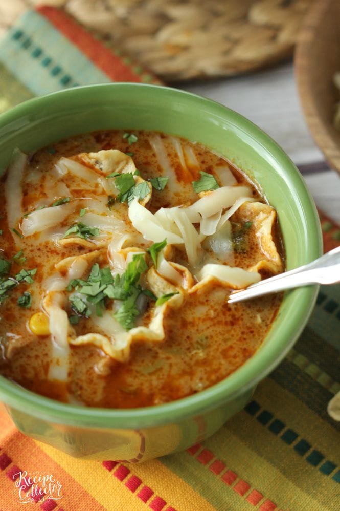 Cheesy Chicken Tortilla Soup - Comforting soup filled with chicken, onions, peppers, black beans, corn, and finished off with a little cream to give it that extra little something!