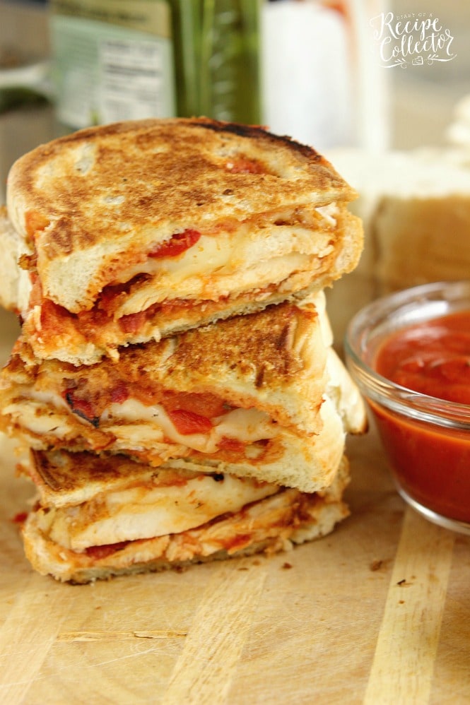 Chicken Parmesan Panini - Grilled sandwiches filled with crispy, breaded chicken breasts topped with marinara sauce, provolone, and roasted red bell peppers.