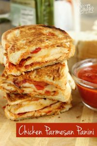 Chicken Parmesan Panini - Grilled sandwiches filled with crispy, breaded chicken breasts topped with marinara sauce, provolone, and roasted red bell peppers.