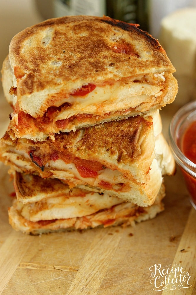 Chicken Parmesan Panini - Grilled sandwiches filled with crispy, breaded chicken breasts topped with marinara sauce, provolone, and roasted red bell peppers.