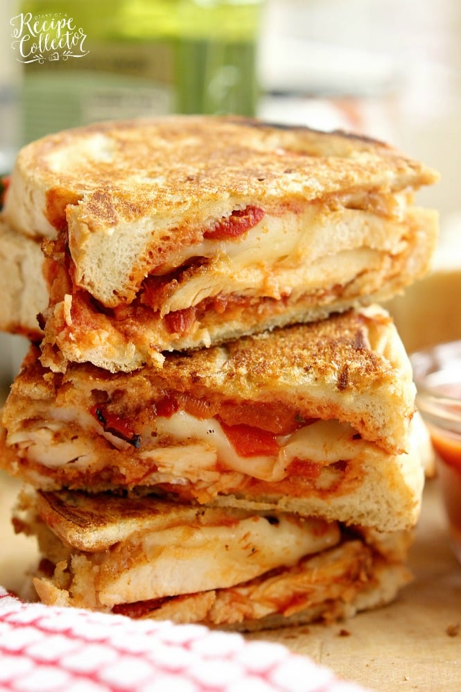 Chicken Parmesan Panini - Grilled sandwiches filled with crispy, breaded chicken breasts topped with marinara sauce, provolone, and roasted red bell peppers.