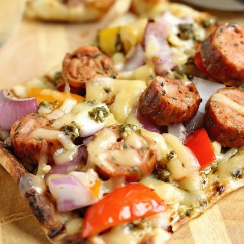 Grilled Sausage & Pepper Pizza - Grill your pizza and top it with delicious Italian Style Smoked Chicken Sausage, peppers, onions, basil pesto, and Fontina cheese.
