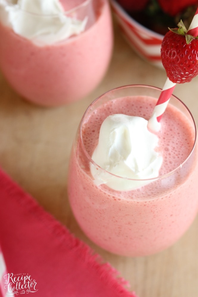 Strawberry Fiesta Daiquiri - A perfect summer cocktail made with frozen strawberries, pina colada mix, coconut rum, and cool whip! It's a creamy, fun, and delicious drink perfect for summer parties by the pool. Plus it can easily be made non-alcoholic too!