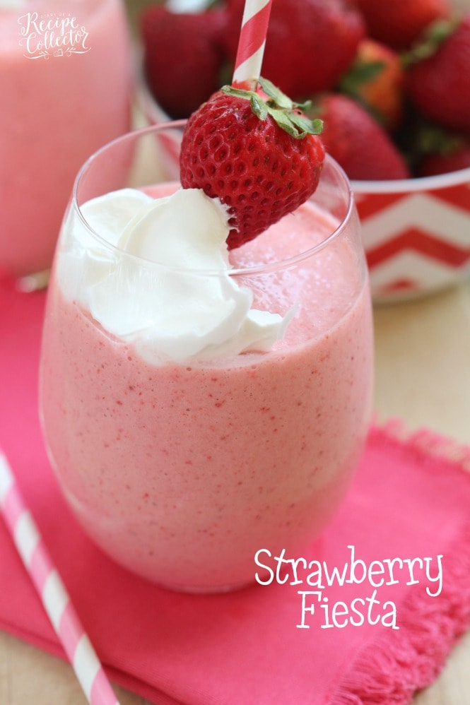 Strawberry Fiesta Daiquiri - A perfect summer cocktail made with frozen strawberries, pina colada mix, coconut rum, and cool whip! It's a creamy, fun, and delicious drink perfect for summer parties by the pool. Plus it can easily be made non-alcoholic too!