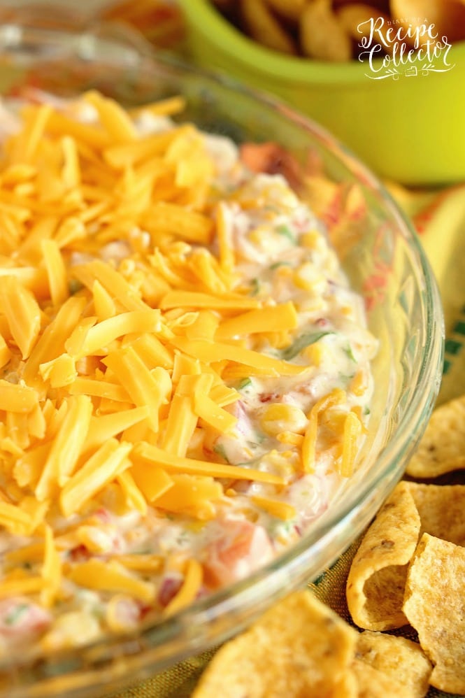 Fiesta Corn Dip - This corn dip version has that spicy-sweet kick with the help of pepper jelly, whipped cream cheese, and pico de gallo! It's a great make ahead dip recipe idea too!