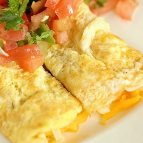 Egg Crepes - A simple, breakfast egg crepe filled with cheese and topped with pico de gallo. It's an easy and perfect breakfast recipe when you are trying to cut the carbs!