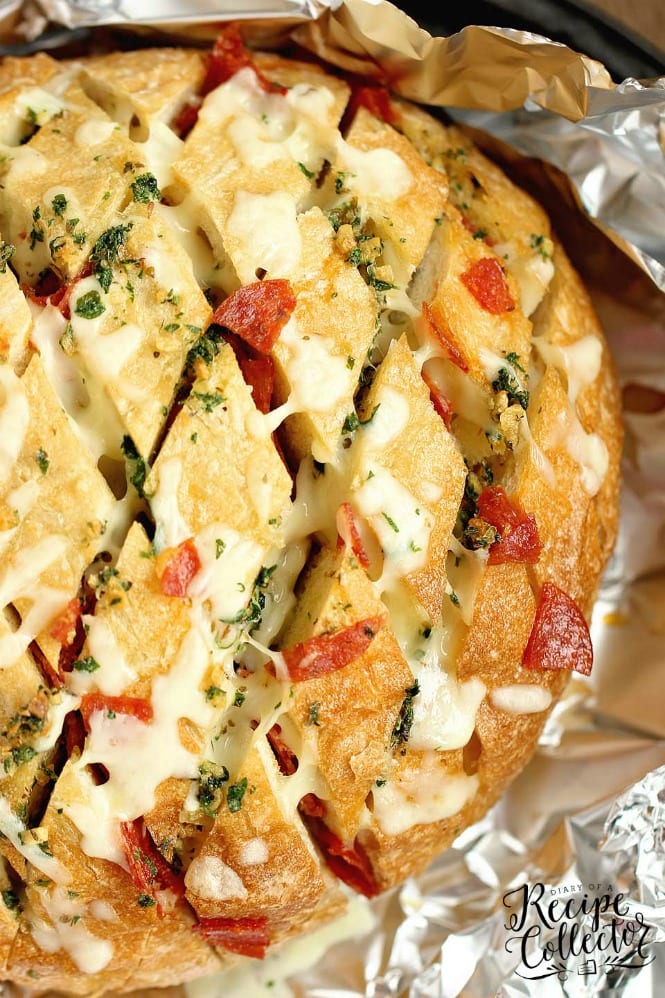 Cheesy Pepperoni Garlic Pull Apart Bread is a packed with tons of garlic herb flavor and makes the perfect appetizer and snack idea!