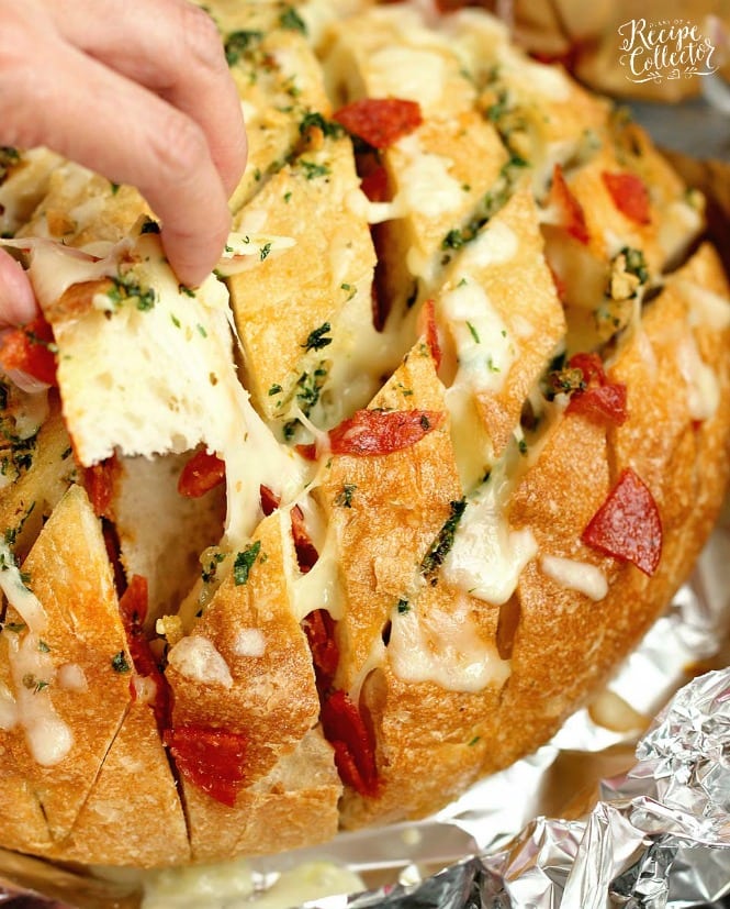 Cheesy Pepperoni Garlic Pull Apart Bread is a packed with tons of garlic herb flavor and makes the perfect appetizer and snack idea!