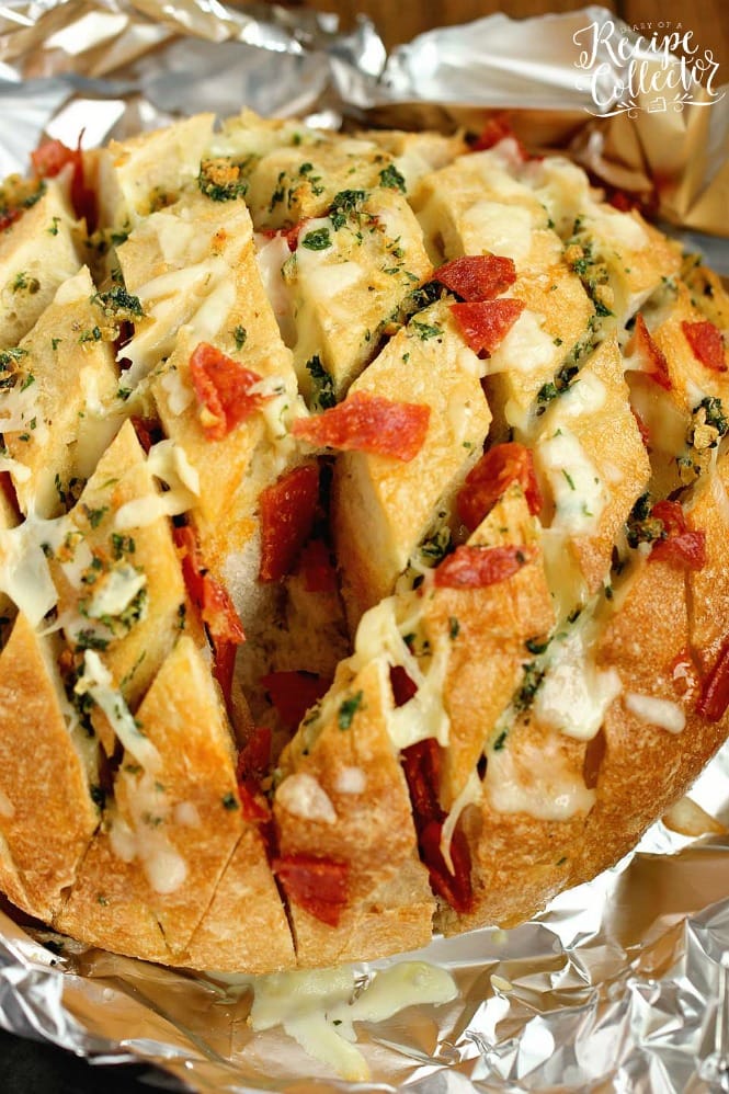Cheesy Pepperoni Garlic Pull Apart Bread is a packed with tons of garlic herb flavor and makes the perfect appetizer and snack idea!
