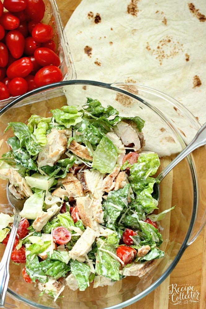 Chicken Caesar Wrap - A quick and easy lunch or dinner recipe filled with grilled chicken, chopped romaine, grape tomatoes, Parmesan cheese, and caesar dressing.  They are great to make ahead for your week too!