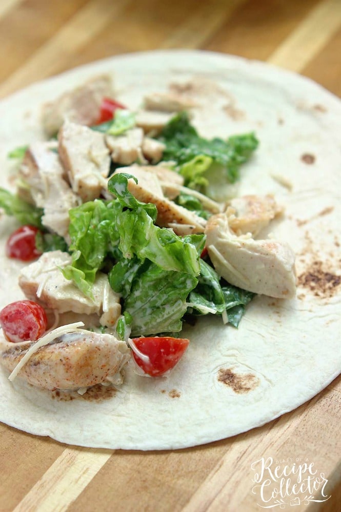 Chicken Caesar Wrap - A quick and easy lunch or dinner recipe filled with grilled chicken, chopped romaine, grape tomatoes, Parmesan cheese, and caesar dressing.  They are great to make ahead for your week too!