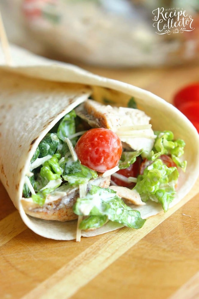 Chicken Caesar Wrap - A quick and easy lunch or dinner recipe filled with grilled chicken, chopped romaine, grape tomatoes, Parmesan cheese, and caesar dressing.  They are great to make ahead for your week too!