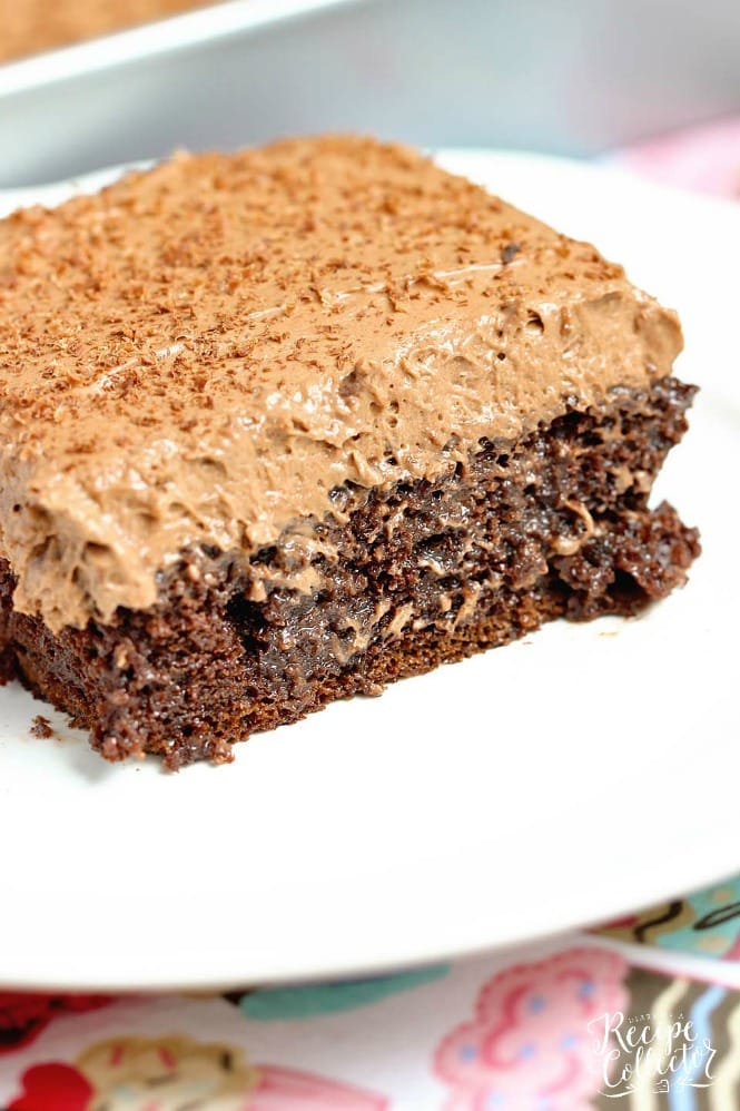 Double Mocha Poke Cake - An easy poke cake recipe using a box cake mix doctored up with pudding mix, sweetened condensed milk and expresso powder. It's topped with a heavenly mocha pudding whipped icing!