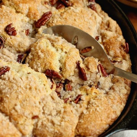 Easy Peach Pecan Skillet Cake - A simple and comforting peach dessert with some surprising ingredients in the batter that make this cake divine!