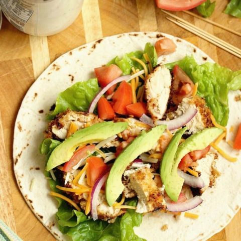 Crispy Chicken Wrap - Stuffed with panko-coated chicken, diced tomatoes, sliced red onion, avocado, shredded cheese, and ranch dressing.  It makes a great weeknight dinner or lunch idea!