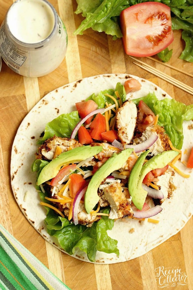 Crispy Chicken Wrap - Stuffed with panko-coated chicken, diced tomatoes, sliced red onion, avocado, shredded cheese, and ranch dressing.  It makes a great weeknight dinner or lunch idea!