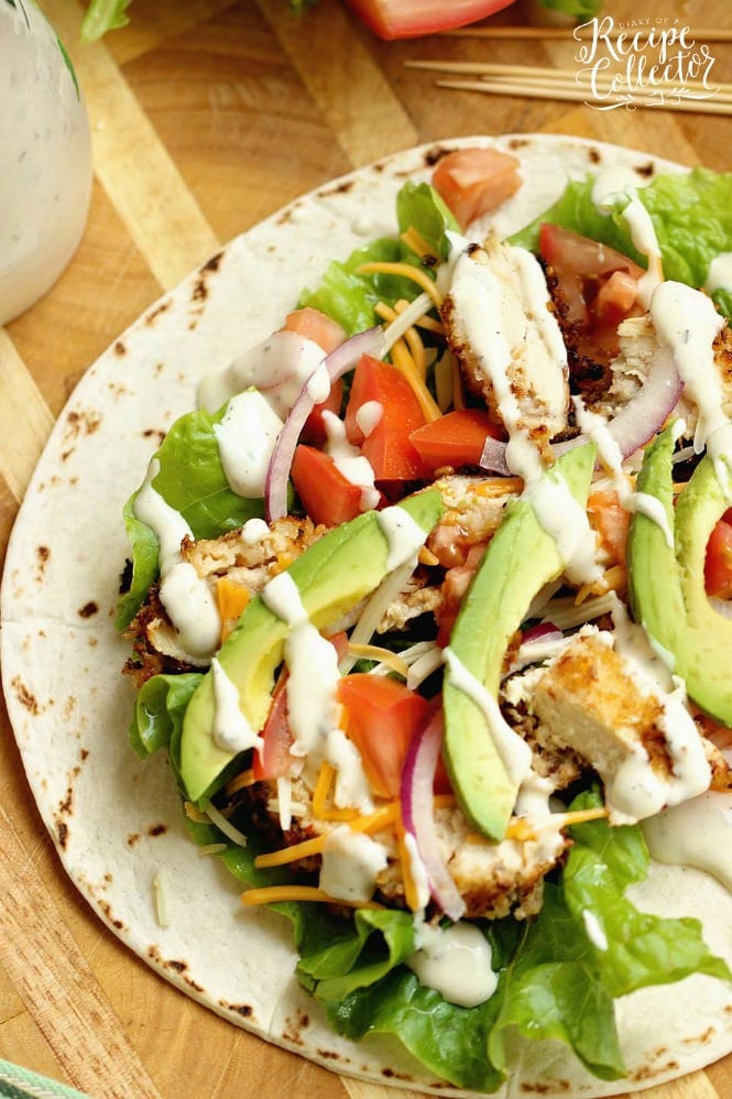Crispy Chicken Wrap - Stuffed with panko-coated chicken, diced tomatoes, sliced red onion, avocado, shredded cheese, and ranch dressing.  It makes a great weeknight dinner or lunch idea!