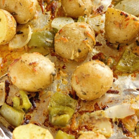 Roasted Creole Potatoes - An easy roasted potato side dish filled with onions, green bell peppers, parmesan cheese, and Creole spices.