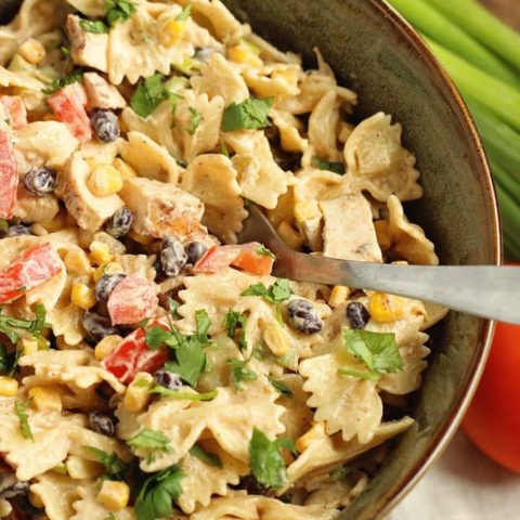 Southwestern Pasta Salad - A creamy pasta salad filled with grilled chicken, black beans, corn, tomatoes, green chiles, cilantro, green onions, and Mexican spices.  