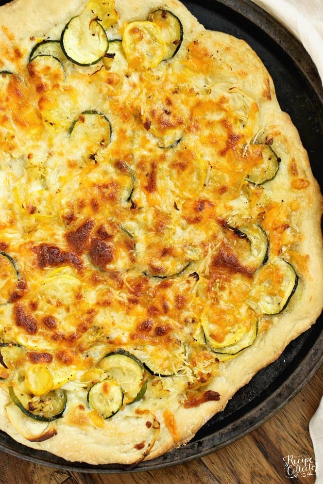 Roasted Veggie Pizza with Garlic Cream Sauce - Oven-roasted yellow squash, zucchini, cauliflower, and onion, three cheeses, and a delicious garlic cream sauce make this pizza out of this world good!