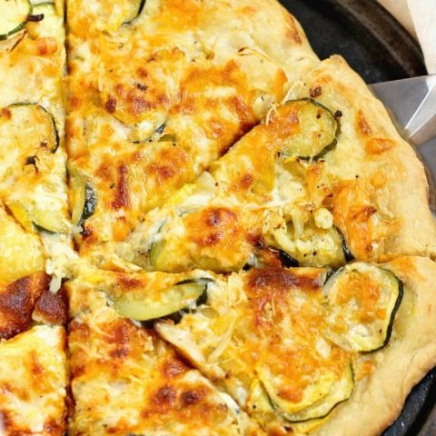 Roasted Veggie Pizza with Garlic Cream Sauce - Oven-roasted yellow squash, zucchini, cauliflower, and onion, three cheeses, and a delicious garlic cream sauce make this pizza out of this world good!