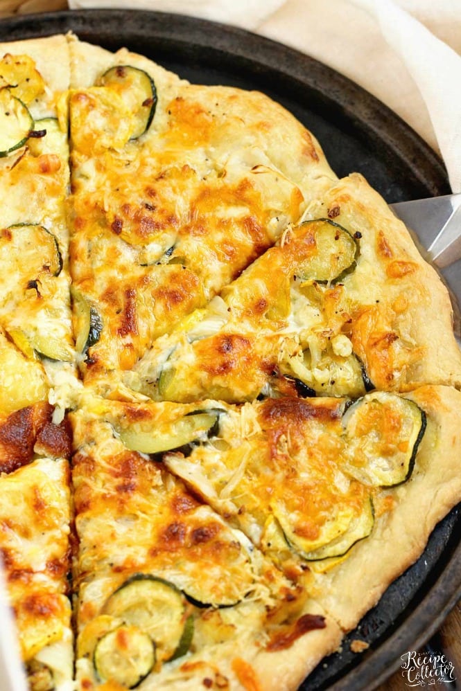 Roasted Veggie Pizza with Garlic Cream Sauce - Oven-roasted yellow squash, zucchini, cauliflower, and onion, three cheeses, and a delicious garlic cream sauce make this pizza out of this world good!