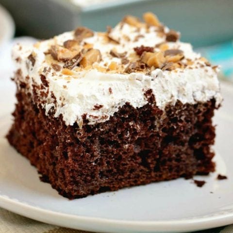 Best Ever Heath Bar Poke Cake - Chocolate cake soaked in sweetened condensed milk, caramel, and hot fudge and topped with heath bar bits and whipped cream.  This is the easiest and most delicious make-ahead dessert ever!