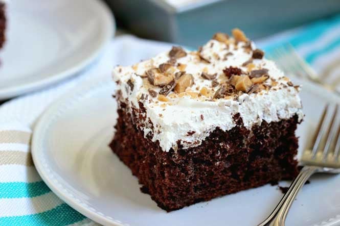 Best Ever Heath Bar Poke Cake - Chocolate cake soaked in sweetened condensed milk, caramel, and hot fudge and topped with heath bar bits and whipped cream.  This is the easiest and most delicious make-ahead dessert ever!