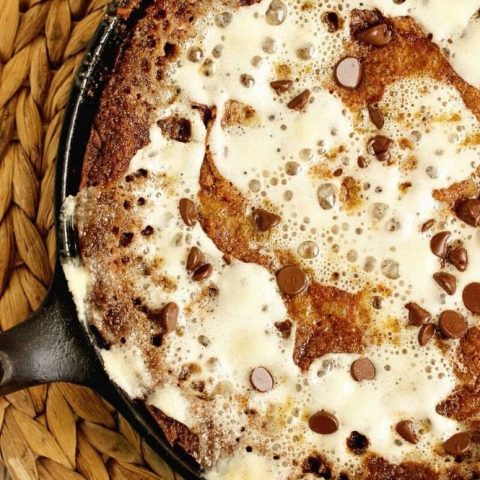S'mores Skillet Cookie Pie - An easy and decadent skillet cookie filled with graham crackers, chocolate, and marshmallows.  This dessert is going to be a FAVORITE!