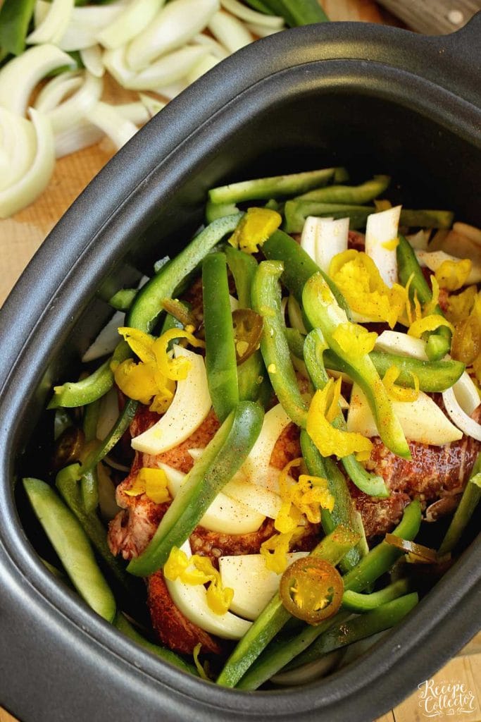 Slow Cooker Southern Cheesesteak Sandwiches - Shredded beef, onions, and peppers piled high with Pepper Jack cheese and served on a toasted kaiser roll.  This is an easy and delicious dinner recipe you must try soon!