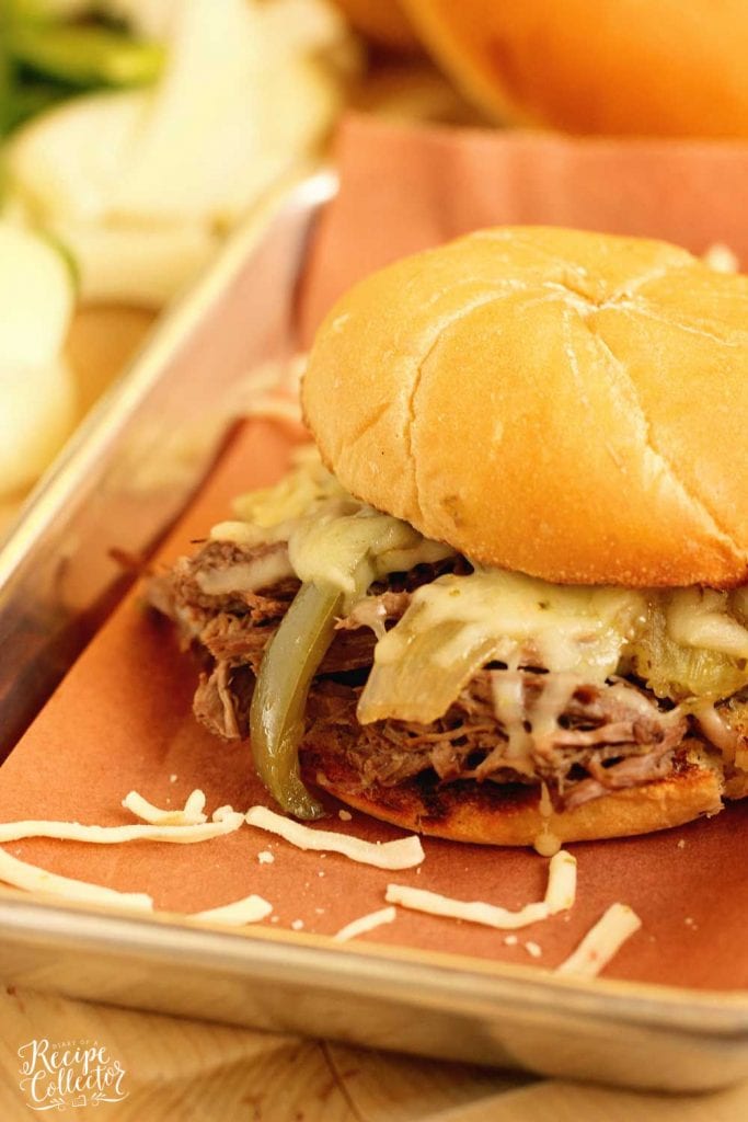 Slow Cooker Southern Cheesesteak Sandwiches - Shredded beef, onions, and peppers piled high with Pepper Jack cheese and served on a toasted kaiser roll.  This is an easy and delicious dinner recipe you must try soon!