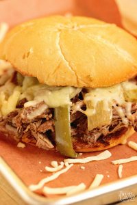 Slow Cooker Southern Cheesesteak Sandwiches - Shredded beef, onions, and peppers piled high with Pepper Jack cheese and served on a toasted kaiser roll.  This is an easy and delicious dinner recipe you must try soon!