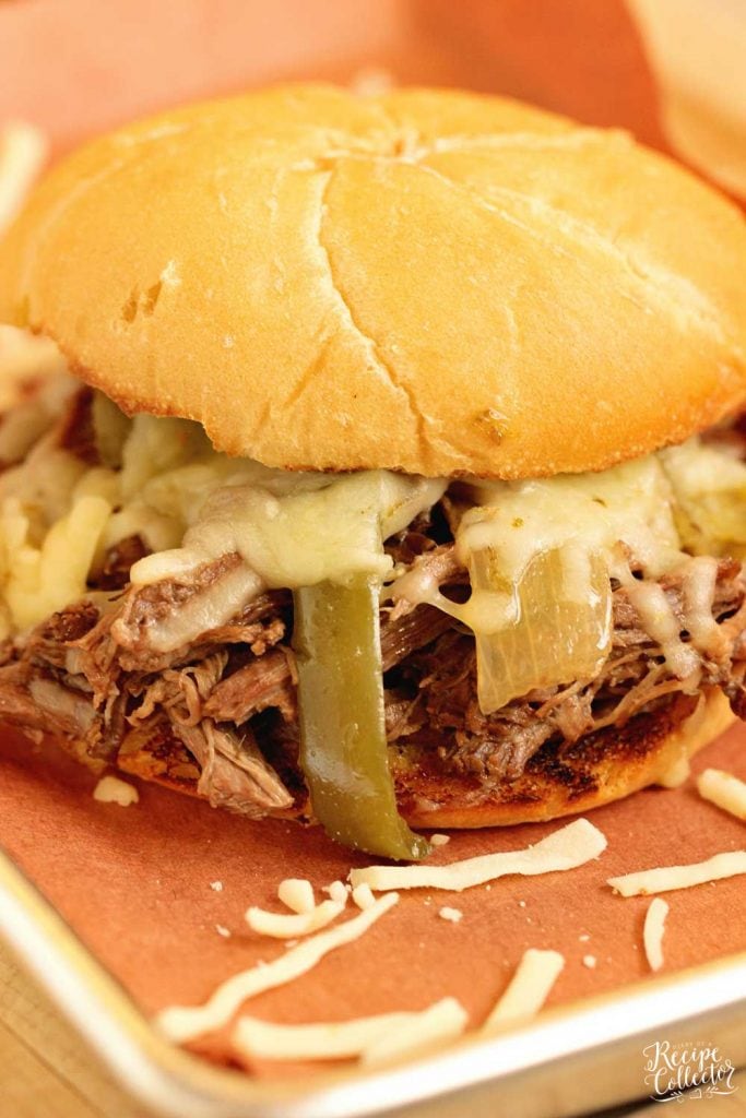 Slow Cooker Southern Cheesesteak Sandwiches - Shredded beef, onions, and peppers piled high with Pepper Jack cheese and served on a toasted kaiser roll. This is an easy and delicious dinner recipe you must try soon!