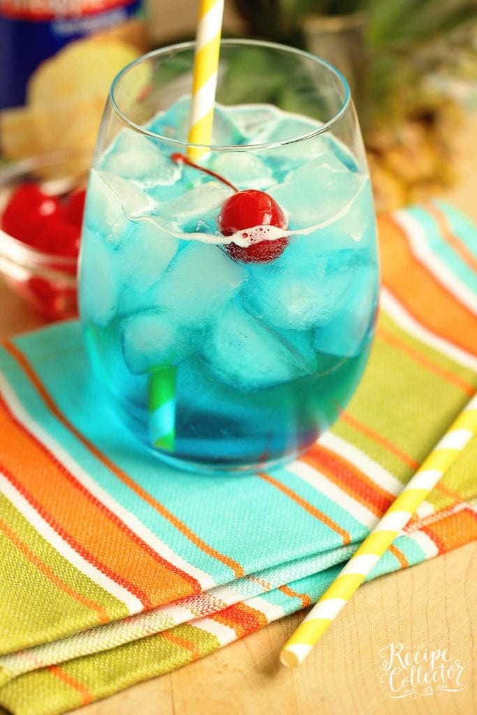 Blue Breeze Cocktail - Transport yourself straight to the beach with this tropical cocktail made with coconut rum, blue curacao, pineapple nectar, and Sprite.