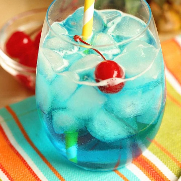 Blue Breeze Cocktail - Transport yourself straight to the beach with this tropical cocktail made with coconut rum, blue curacao, pineapple nectar, and Sprite.