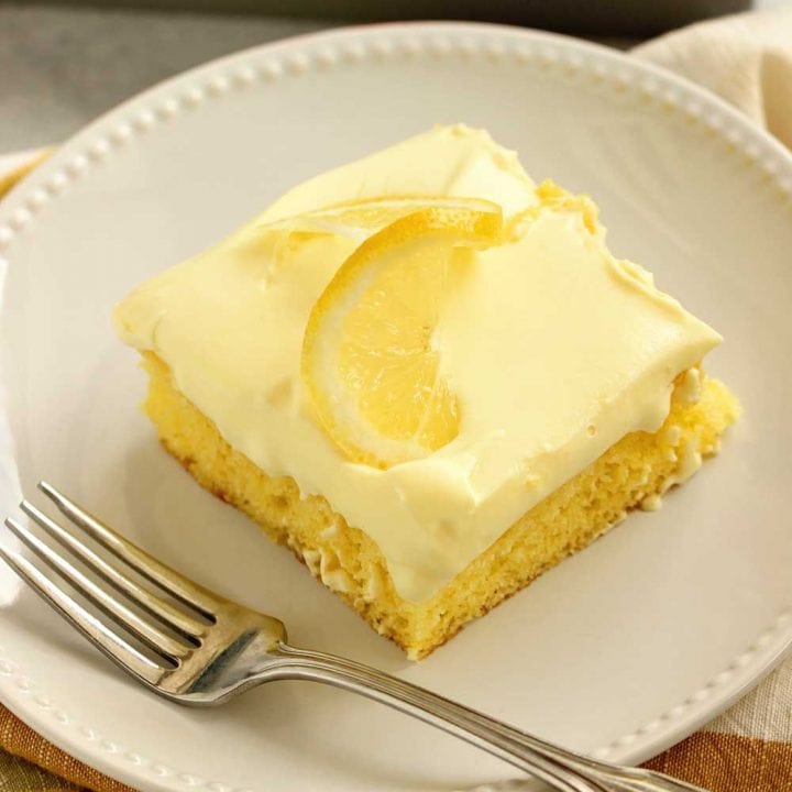 Triple Lemon Poke Cake - An easy lemon cake baked with lemon curd, filled with more lemon curd, and topped with a lemon pudding icing.