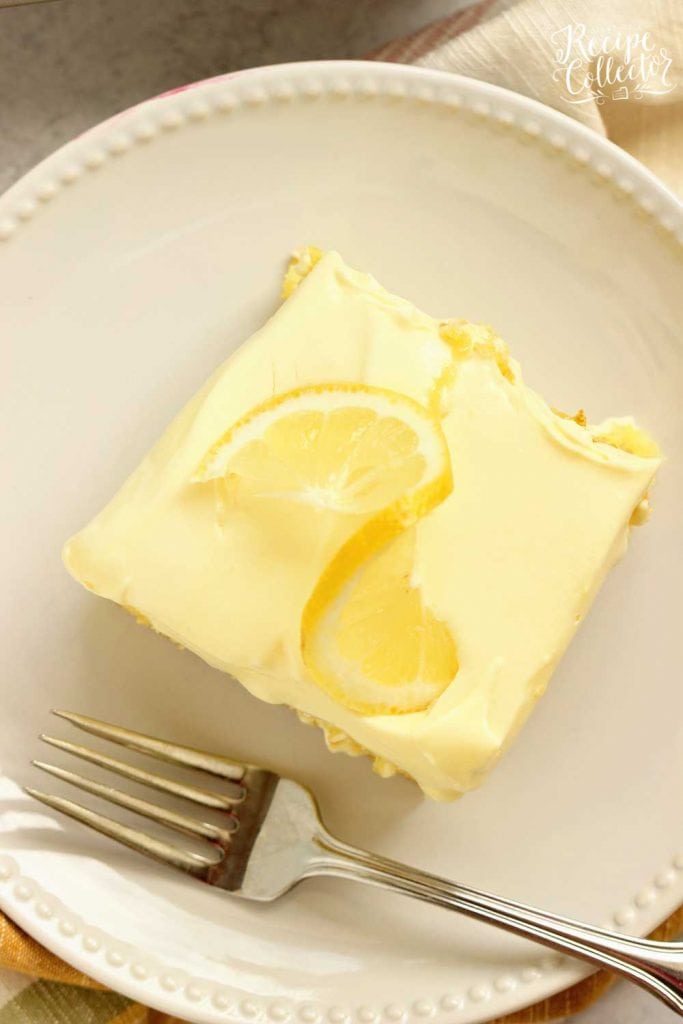 Triple Lemon Poke Cake - An easy lemon cake baked with lemon curd, filled with more lemon curd, and topped with a lemon pudding icing.