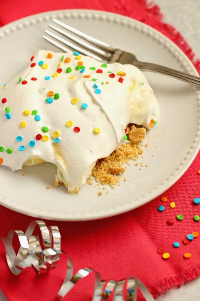 No-Bake Birthday Yummy - Layers of cream cheese pudding and cake batter vanilla pudding piled onto a delicious golden oreo cookie crust!